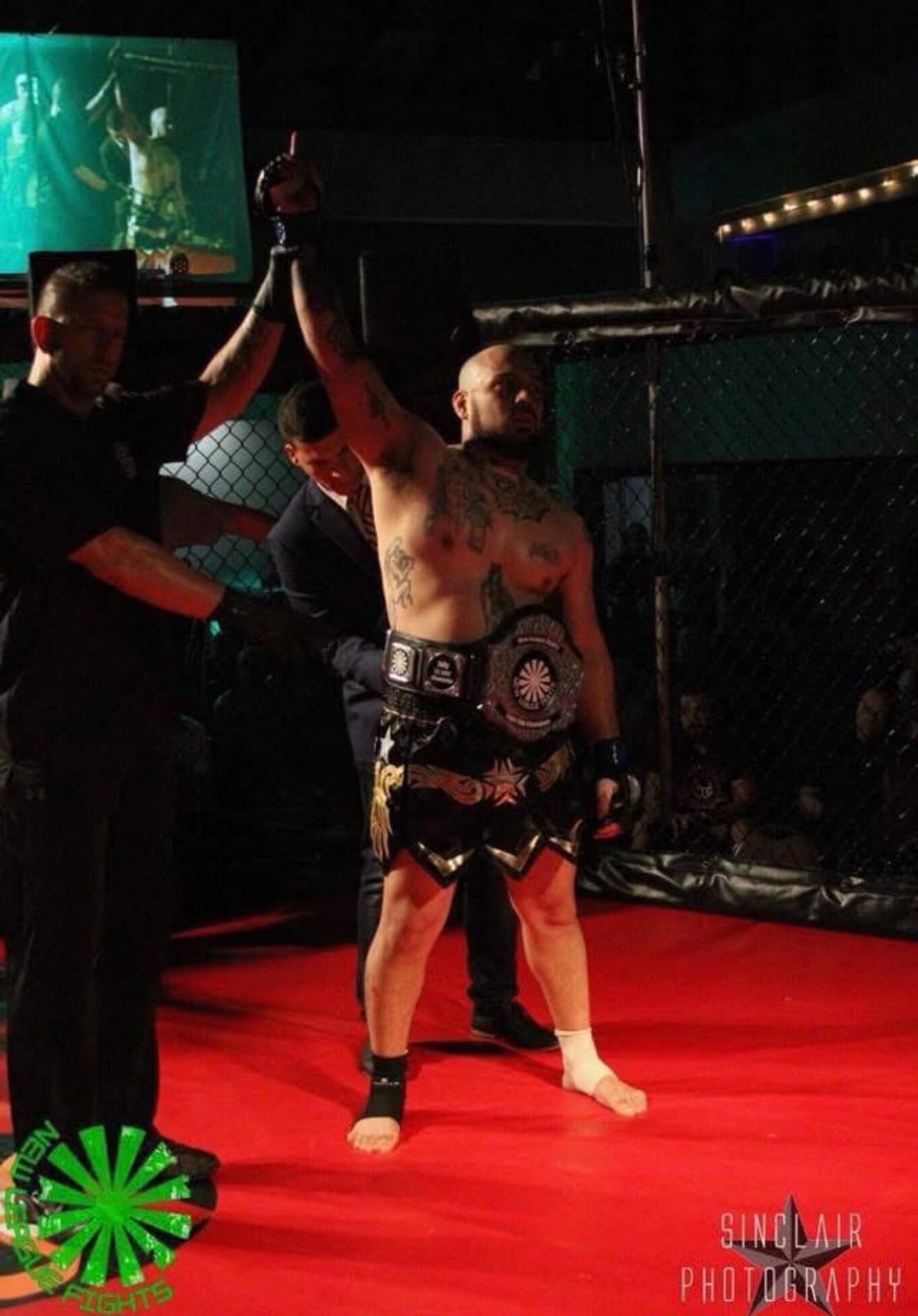 Joe Garcia, professional MMA fighter, in the cage after a championship win